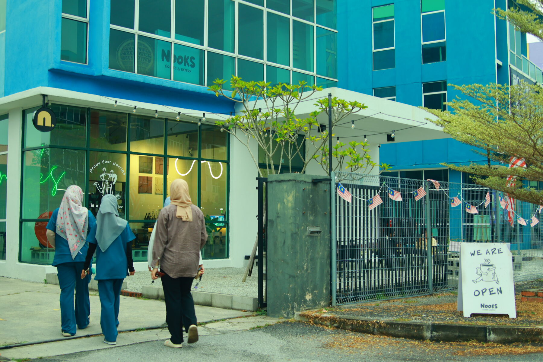 Customers walking into the NOOKS storefront in Meru Raya, Ipoh