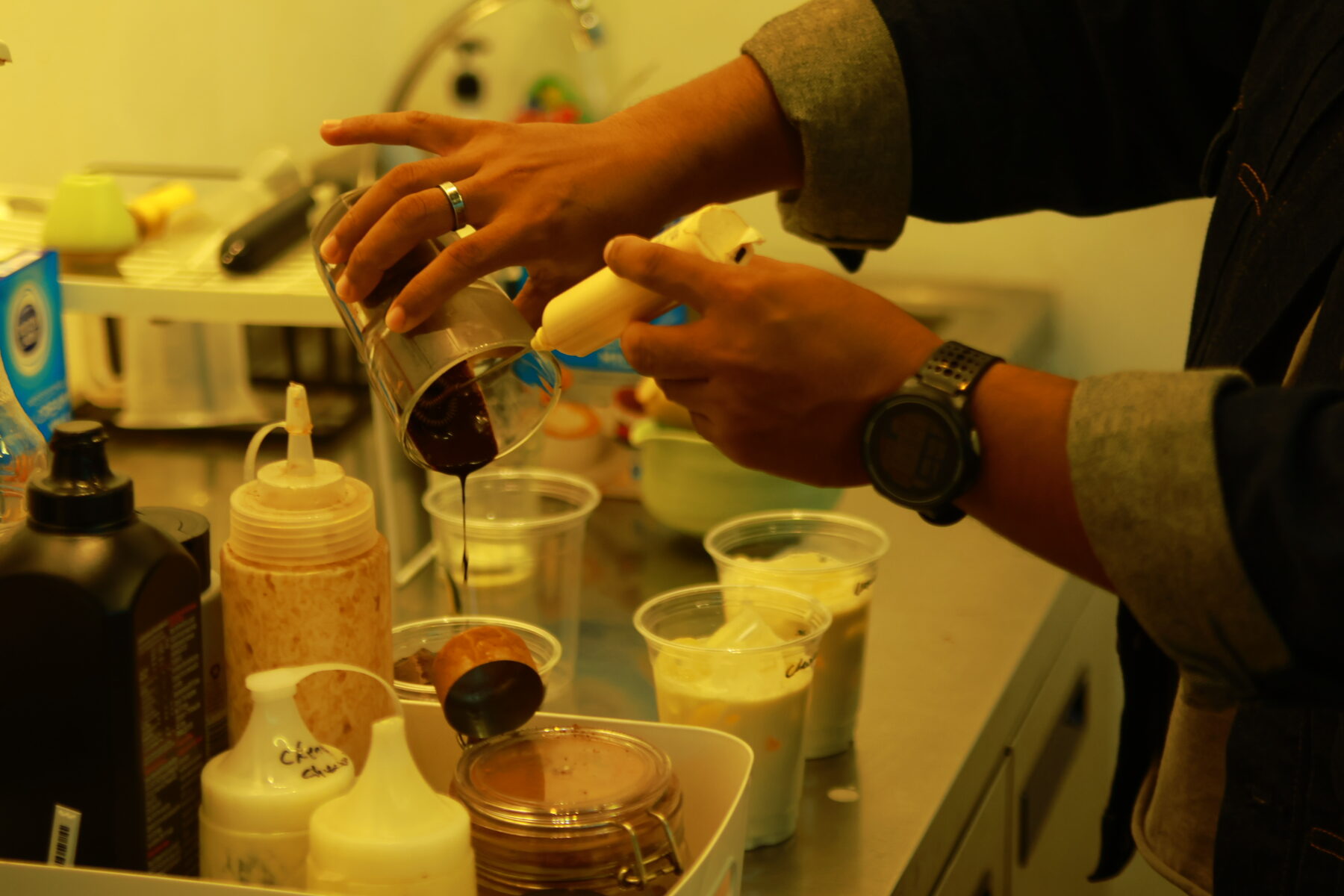 Barista pouring a drink behind the counter