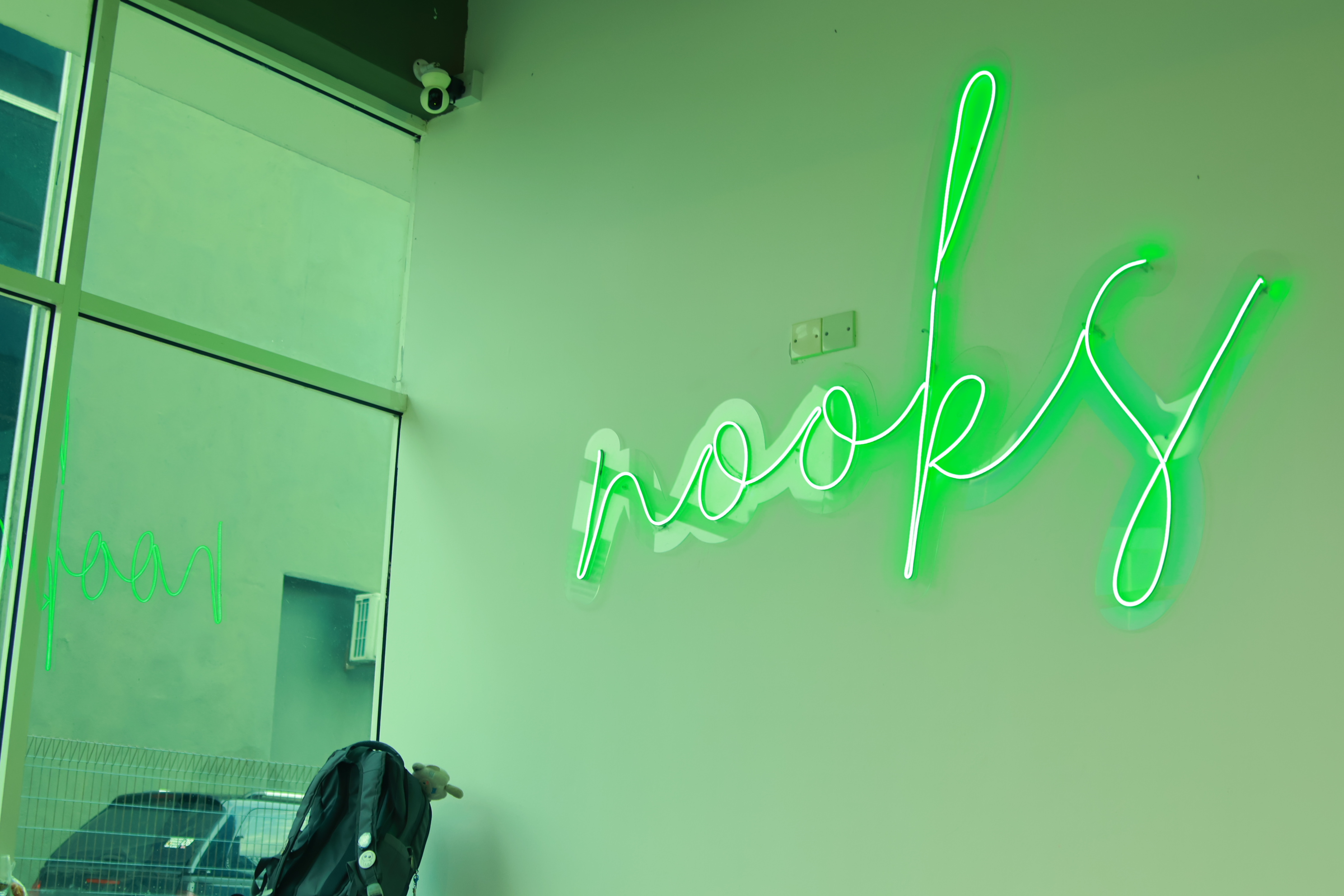 Close-up of the NOOKS neon sign on the wall