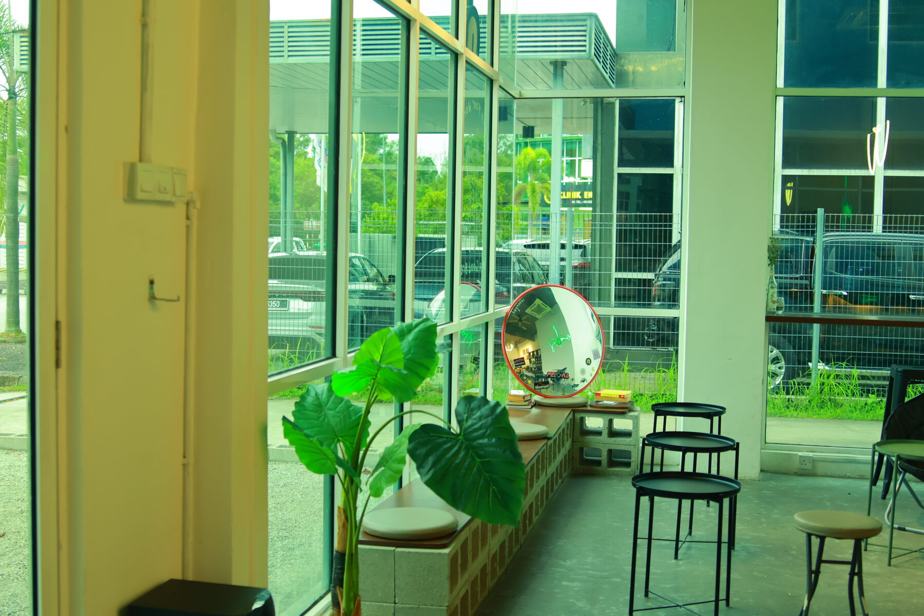 Window-side seating with plants overlooking the street